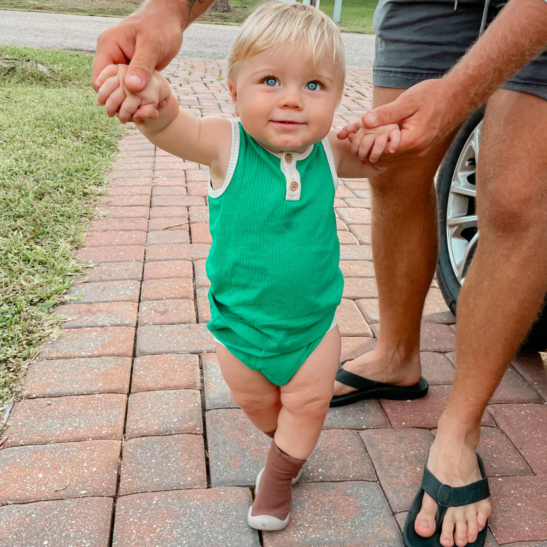Toddler walking in Tiny Explorings sock shoes